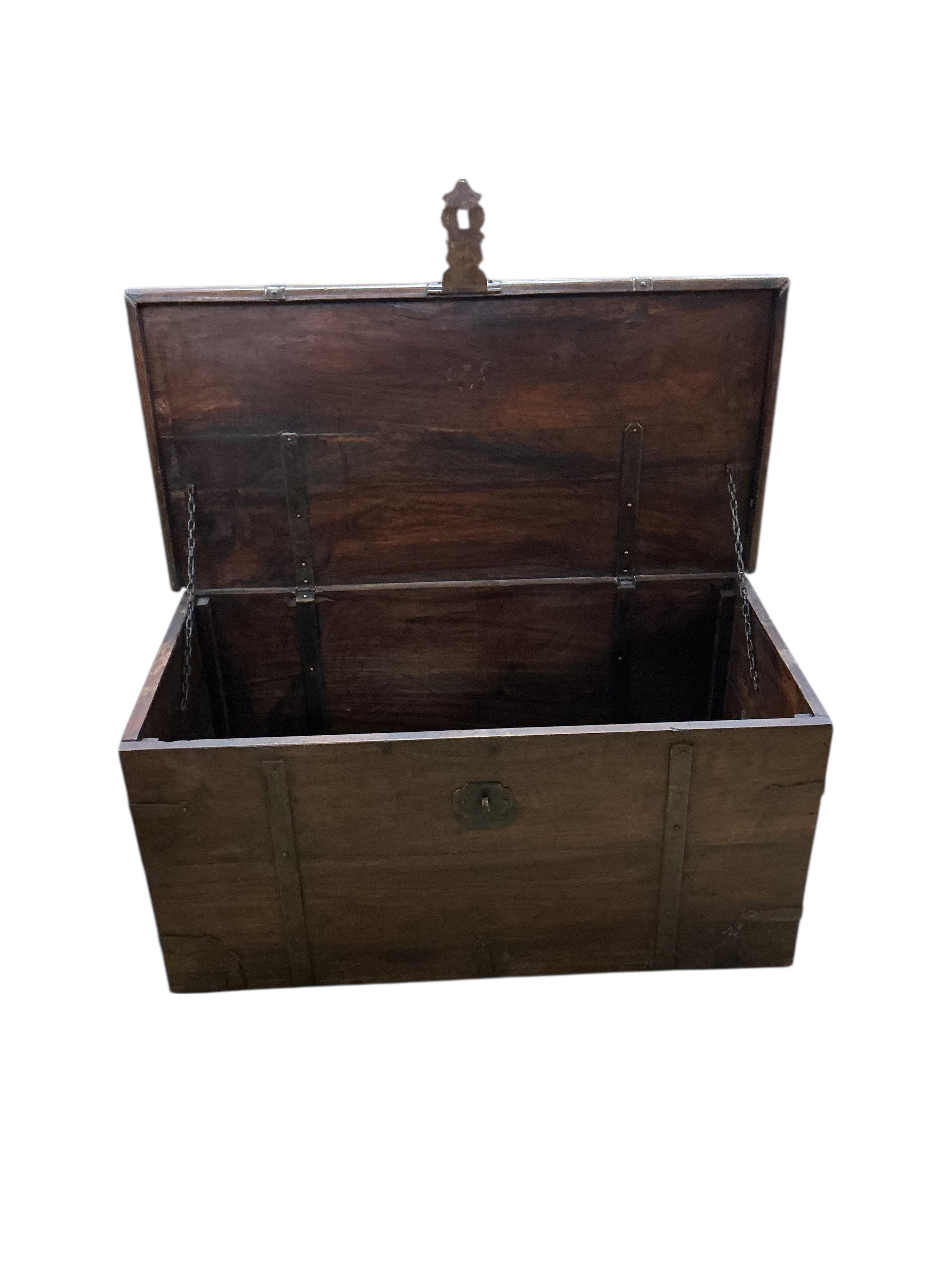 Two Indonesian iron bound hardwood trunks, larger width 80cm, depth 45cm, height 44cm together with a quantity of carvings